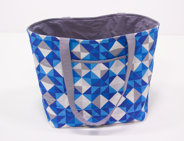 a fabric made handbag with blue square and triangles pattern