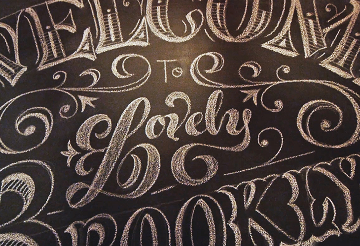 curved typography drawing with serifs and floral motives in between