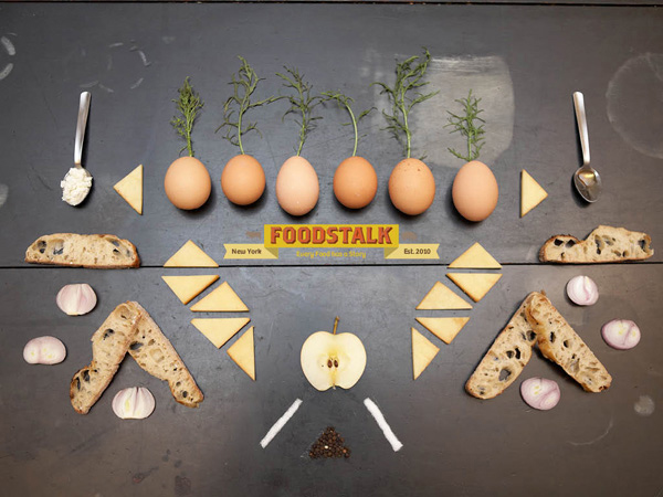 eggs, biscuits and slices of bred laid down on a table with the foodstalk logo in the middle