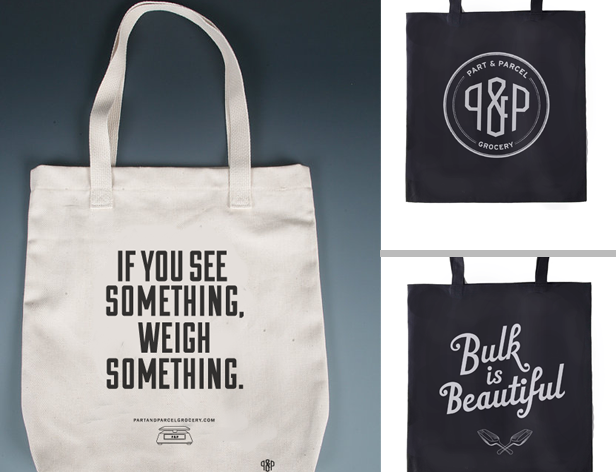 a fabric grocery bag with the message If you see something, weigh something.  q&p logo on a black bag and the typography Bulk is Beautiful on another black bag