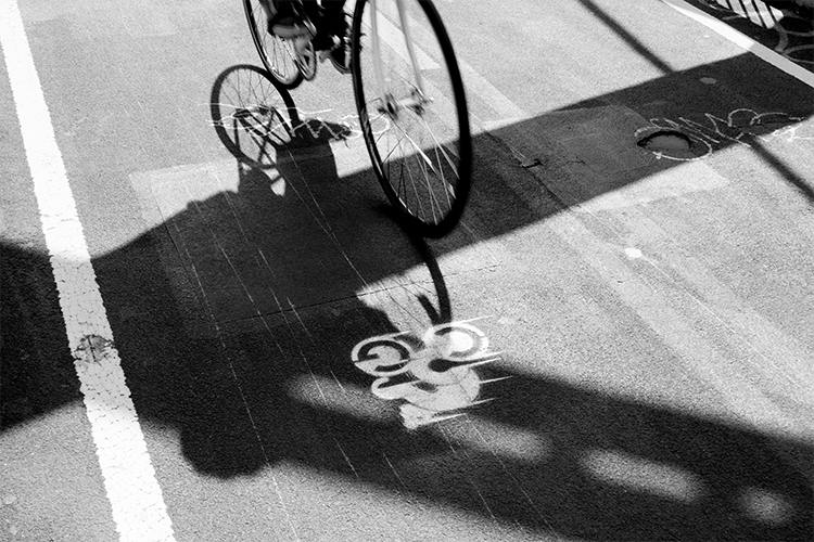 a bike riding over the chain bang logo painted on the tarmac