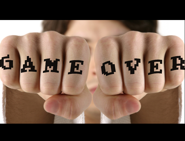 image of a person showing his fists to the camera, and he has written GAME OVER with a letter on each finger