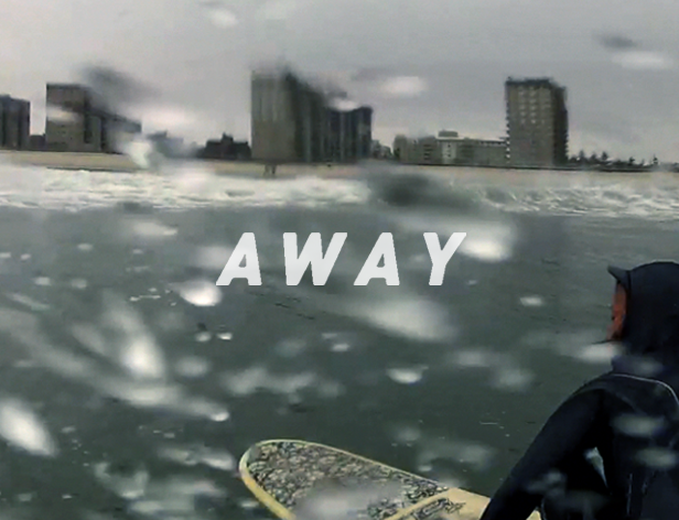 a person with a surfing board on the water and the text AWAY is written over the image