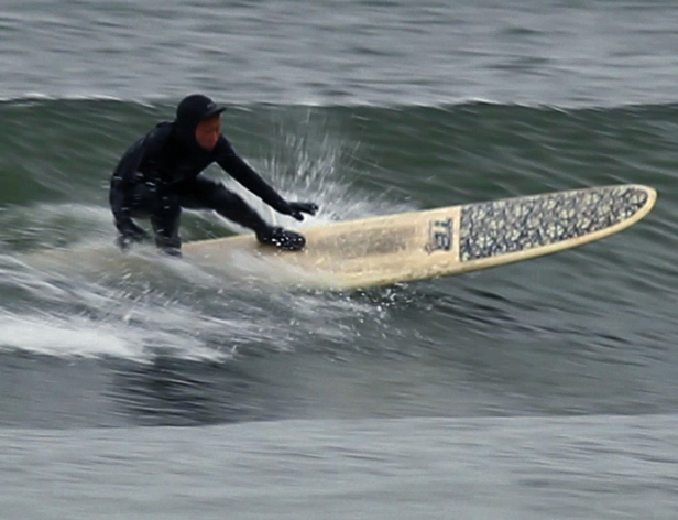 a man surfing a weave with the surf board