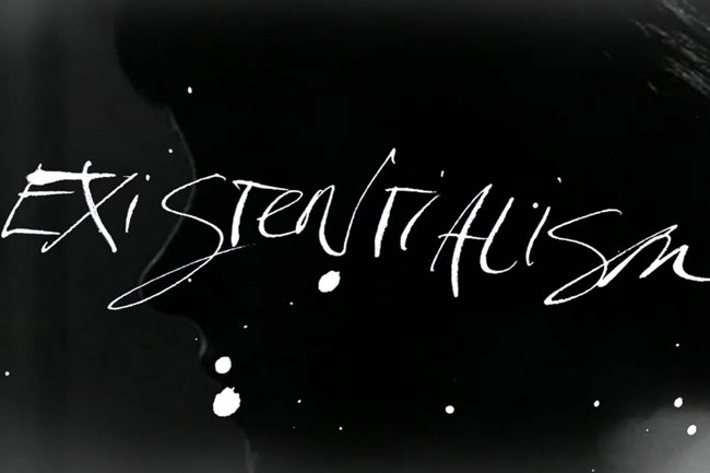 existentialism typography made with white paint on a black surface