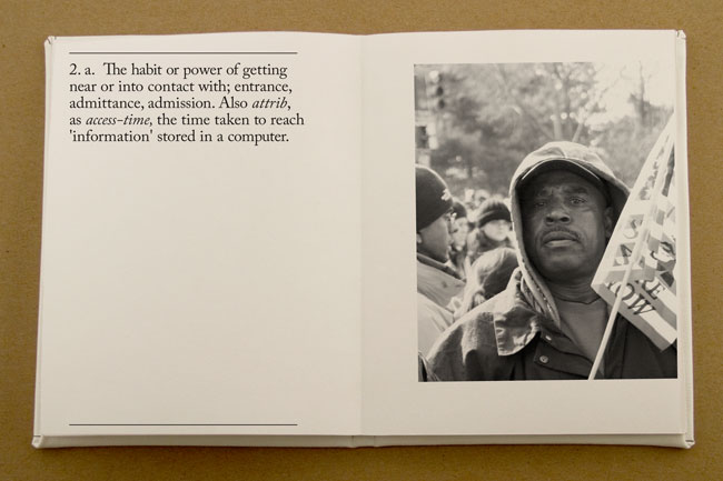 An opened book with a short text on the left page and a photo of a man with a hoodie at a protest
