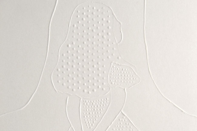 a back view of a sitting girl silhouette created with embossed shapes on a white wall