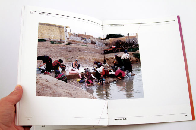 a book opened with an image of people in the water of a river