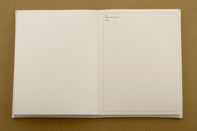 An open book with a blank page on the left and a page with a page-size rectangle with three words in the top left corner