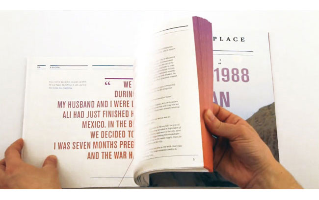 a book held open by two hands to a page with a quote written in orange