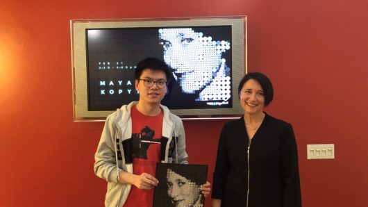 Maya Kopytman's guest lecture with a student holding a poster