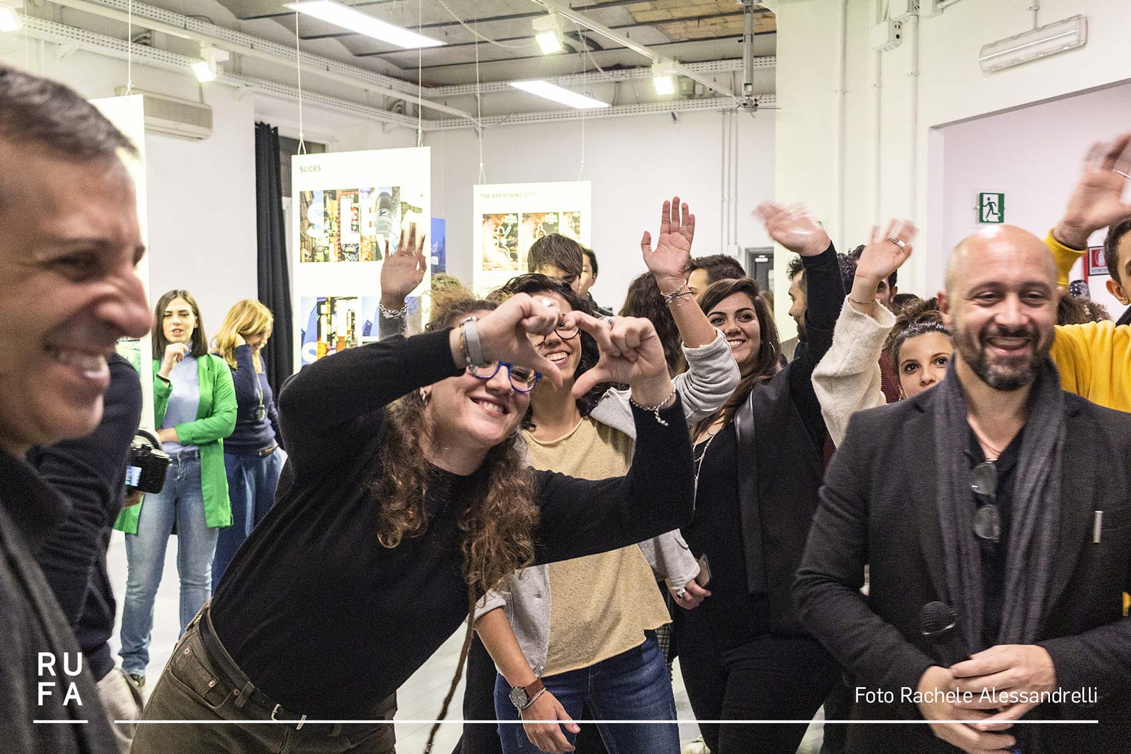 girl throwing a heart sign with her hands and people waving