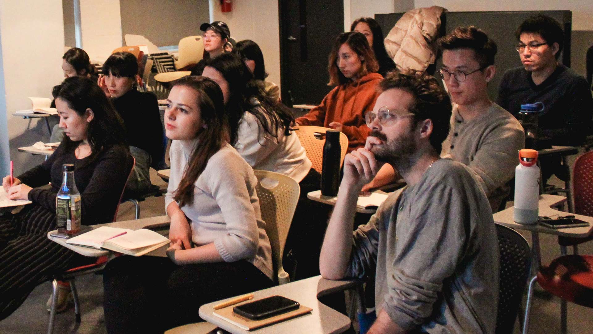 Students at SVA MFA Design watching a lecture in a darkened classroom
