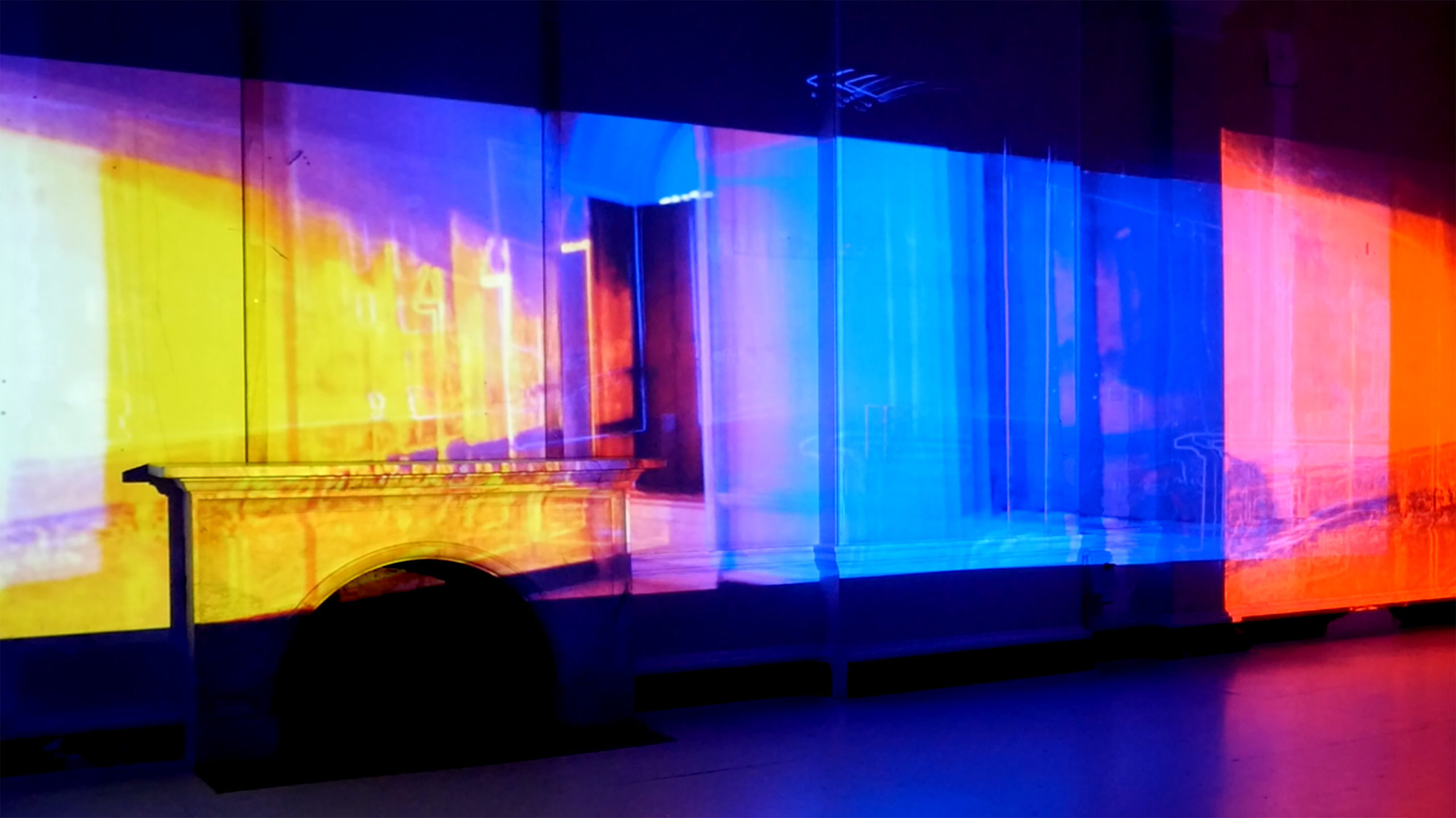 projection of an interior with a fireplace covered in the colors of the spectrum