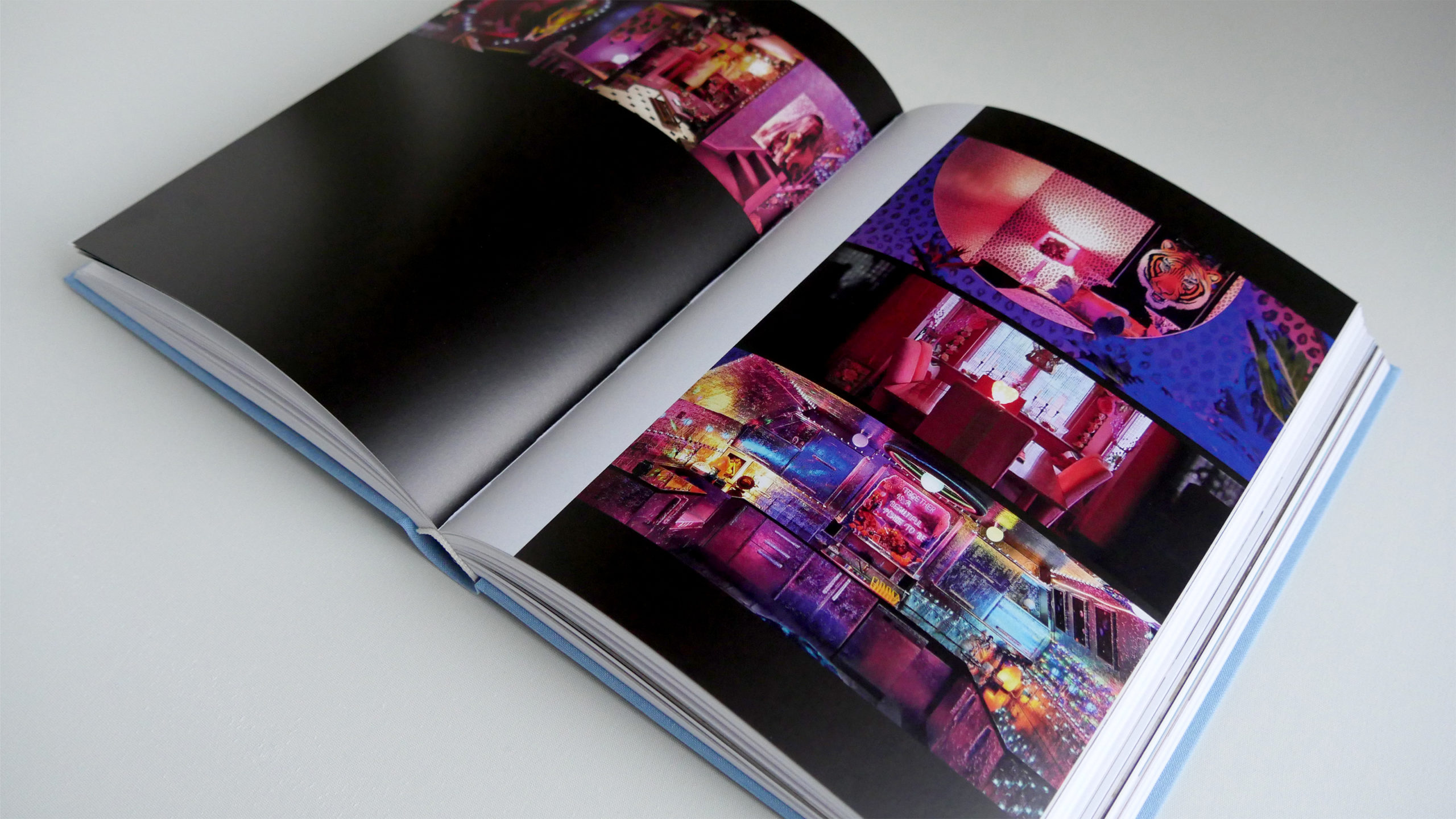 Uchronia book opened to a colorful collaghe of photos