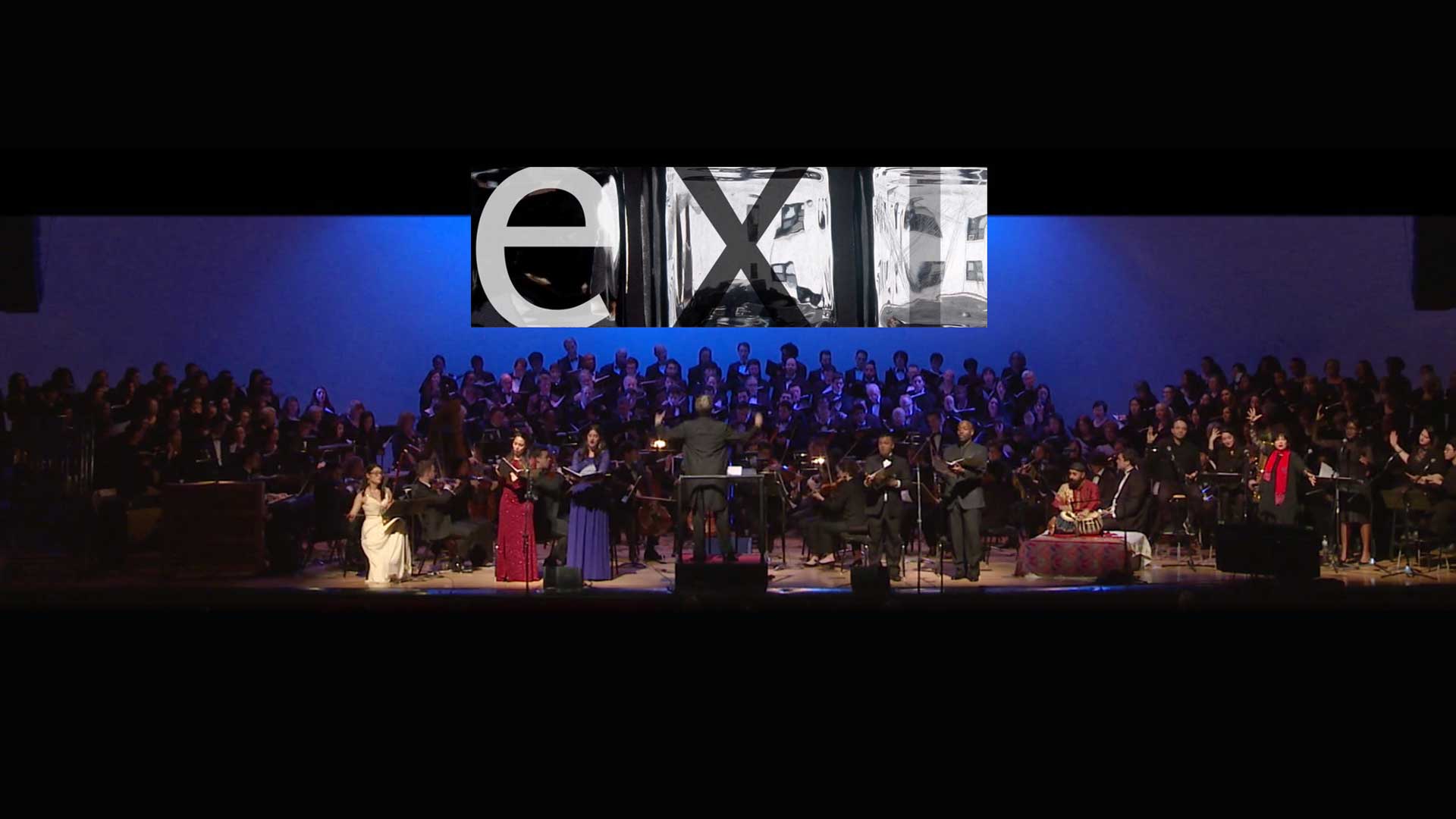 concert stage shot with blue backdrop and the word exit