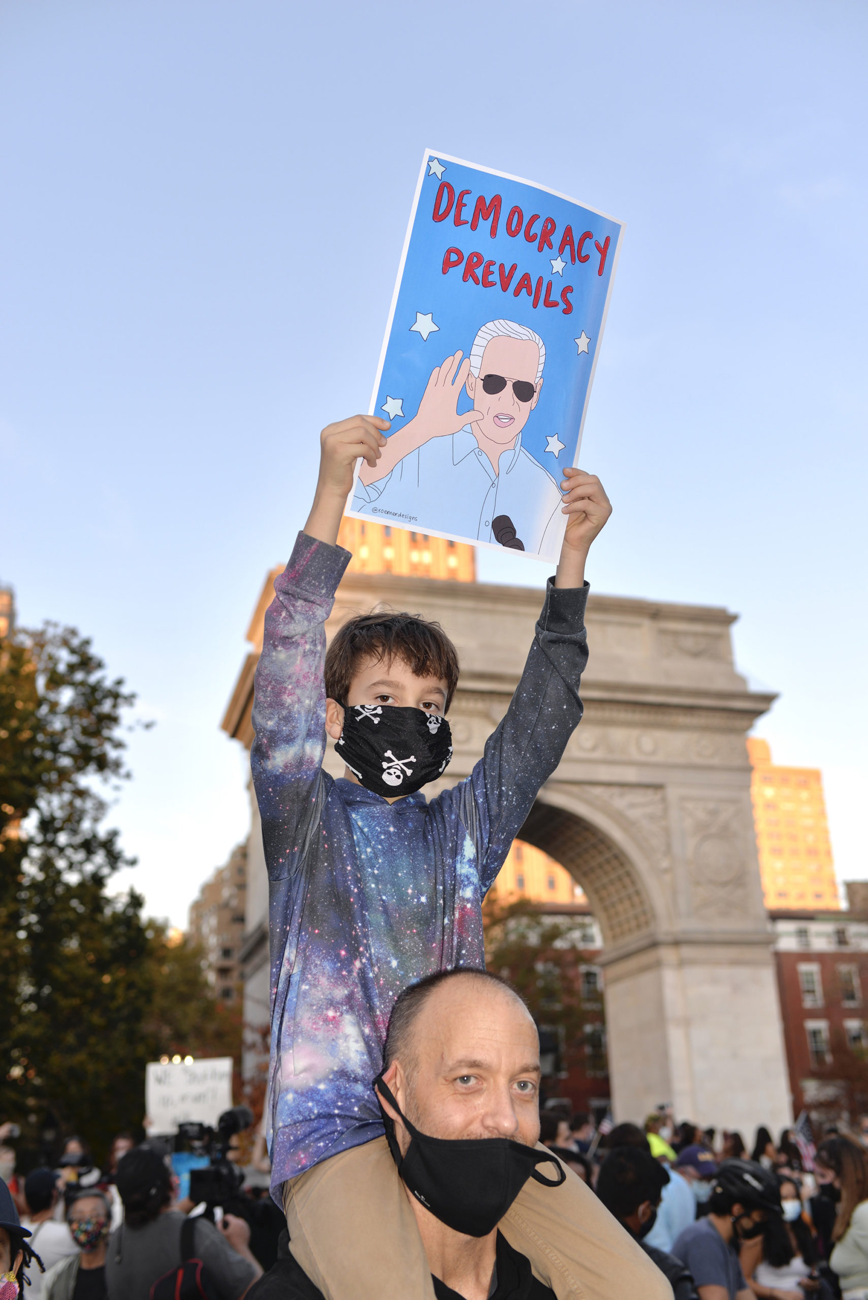 Joe Biden poster with a child and a man