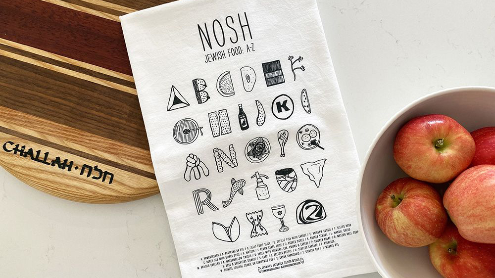 nosh tea towel with cutting board and apples