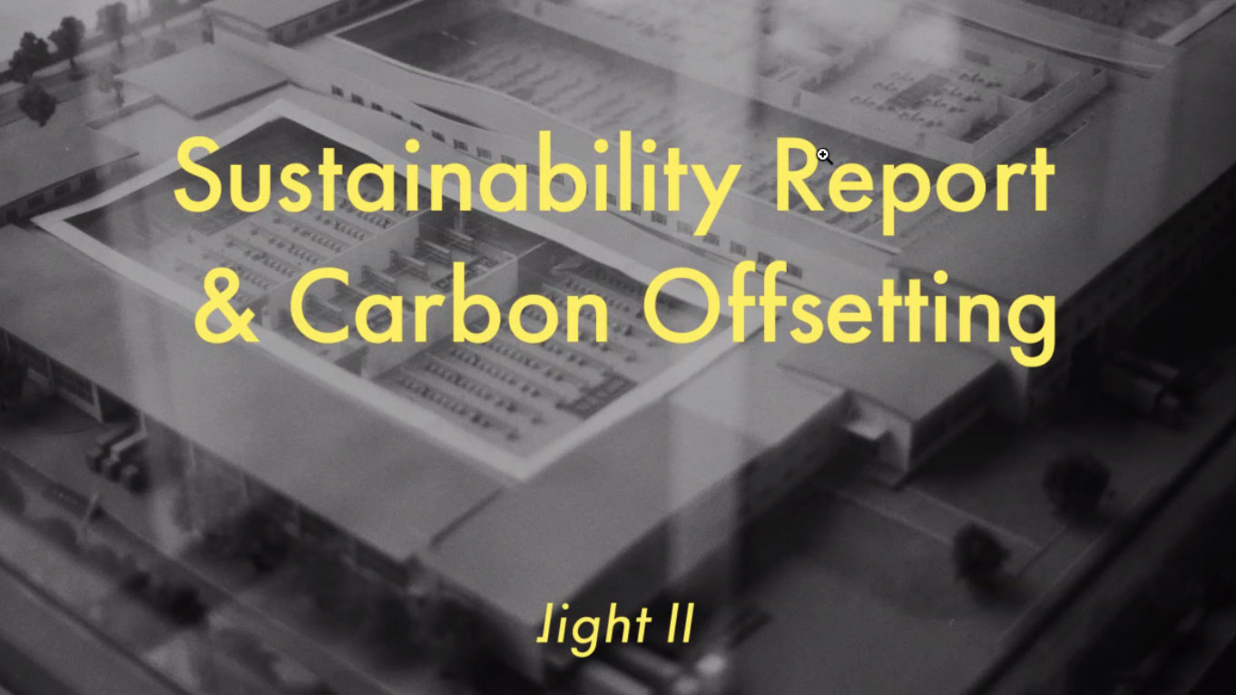 sustainability report ans carbon offsetting in yellow type over a black and white photo of a model building