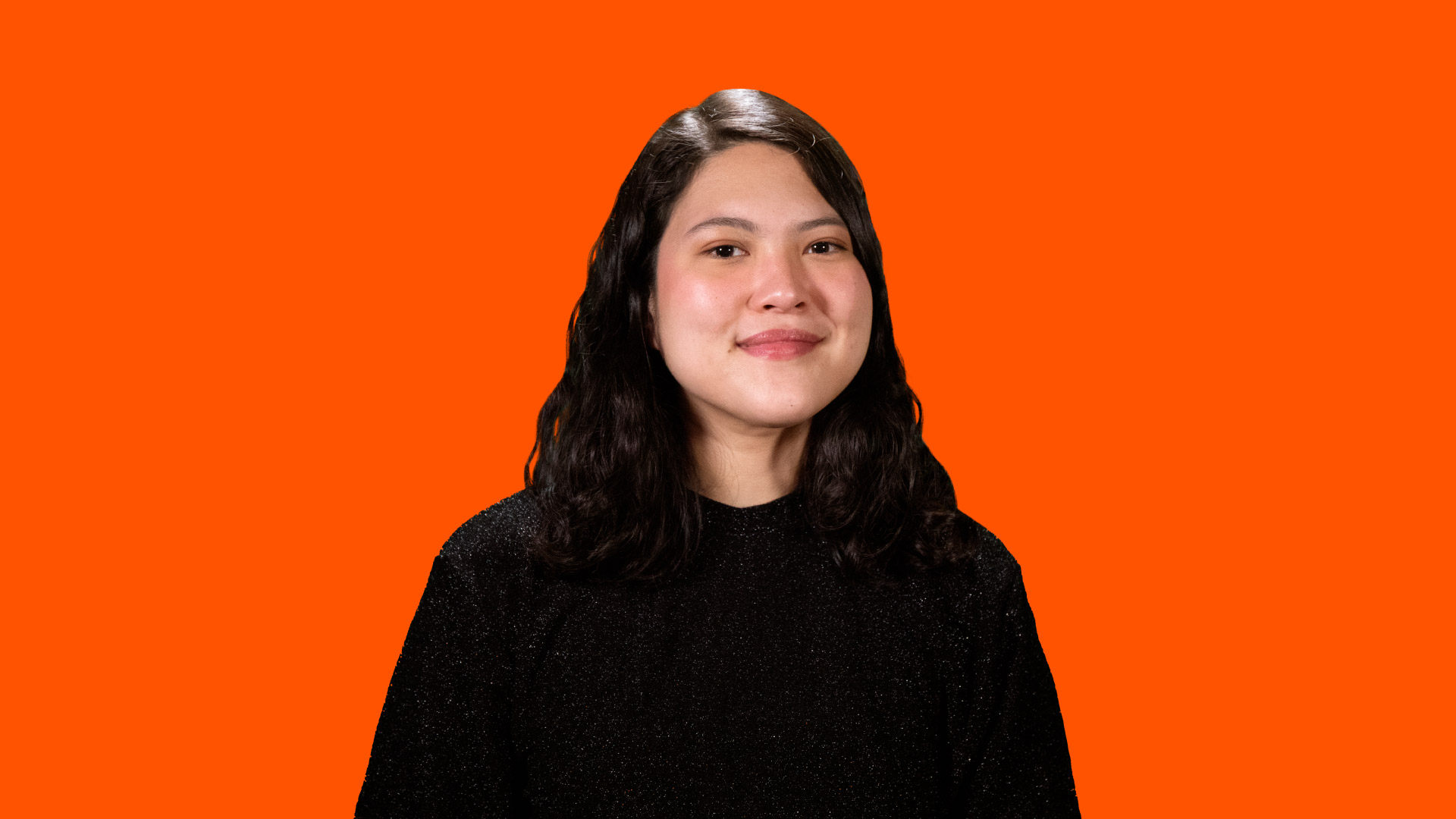 Headshot of Renee Freiha on an orange background