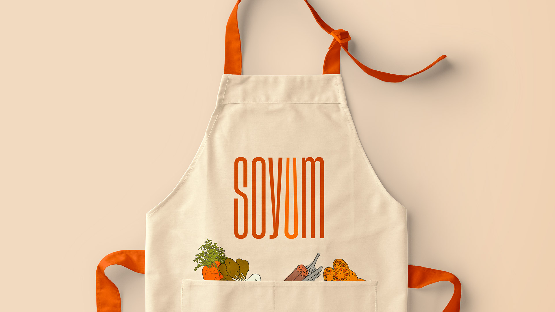 A Soyum Apron with the logo and ingredient illustrations on