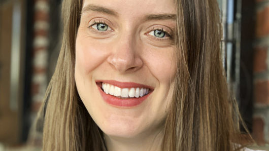 Brunette woman with blue eyes smiling