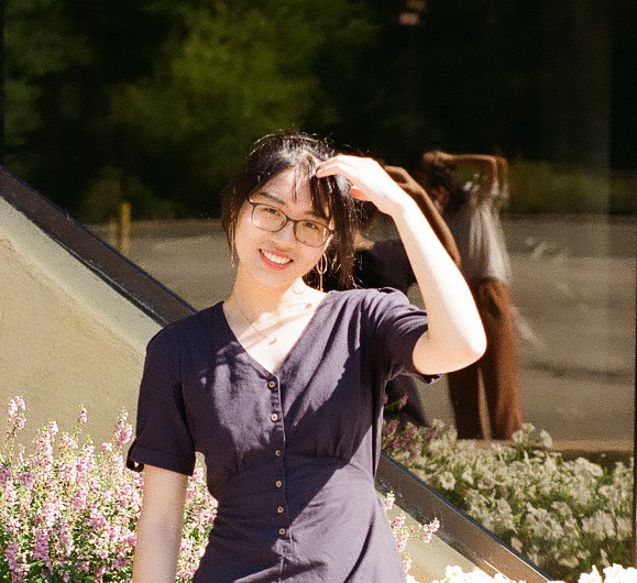 Woman posing in front of flowers