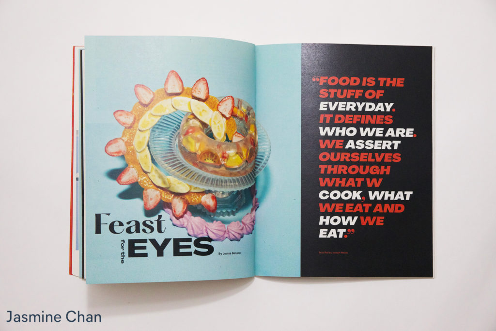 Magazine spread with colorful image of food on the left and on the right red and white text on black background, by Jasmine Chan
