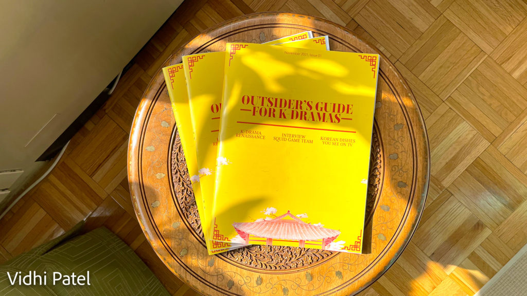 magazine with yellow cover and red text titled outsider's guide for k-dramas, by Vidhi Patel