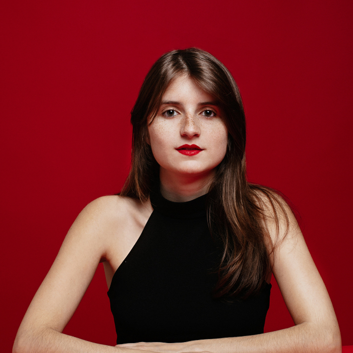 A photo of a woman wearing a black dress.