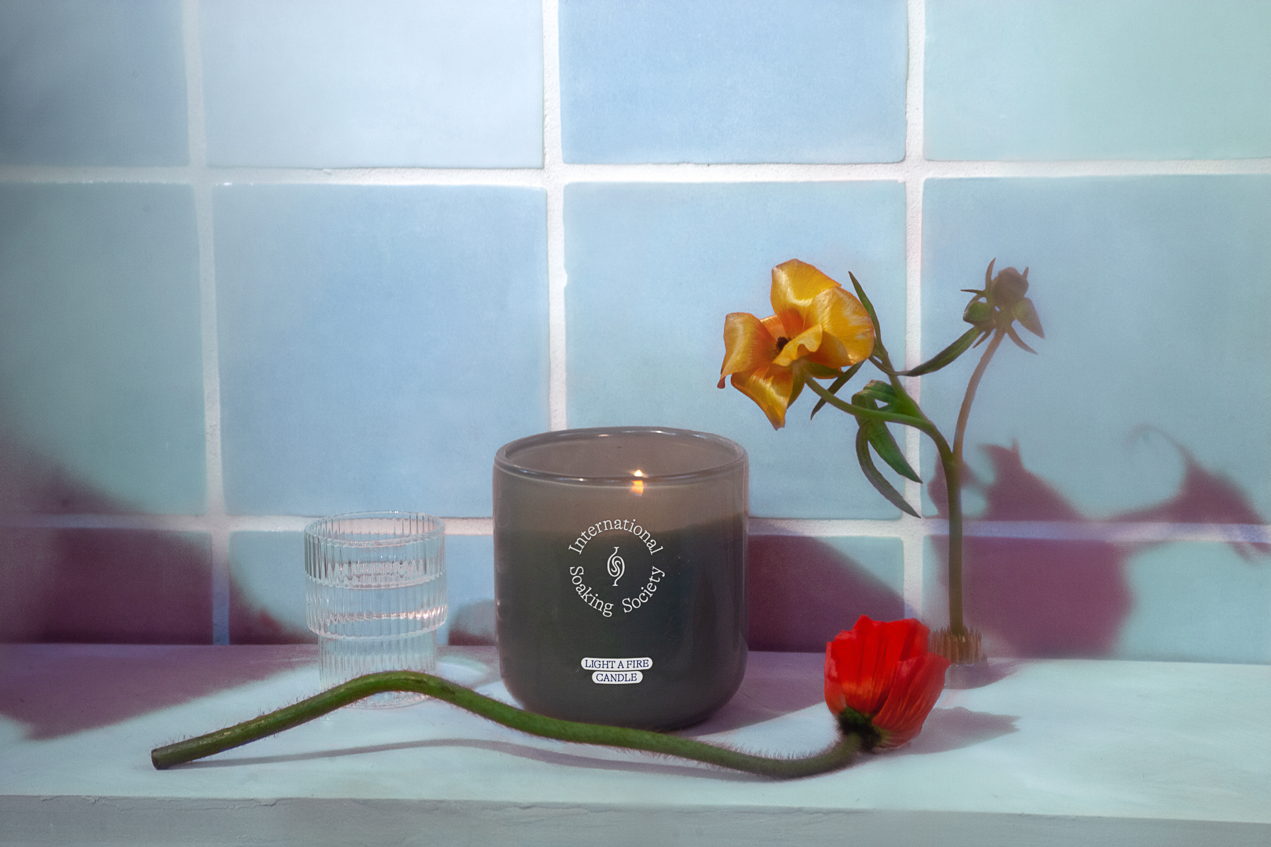 candle in a bathroom with flower