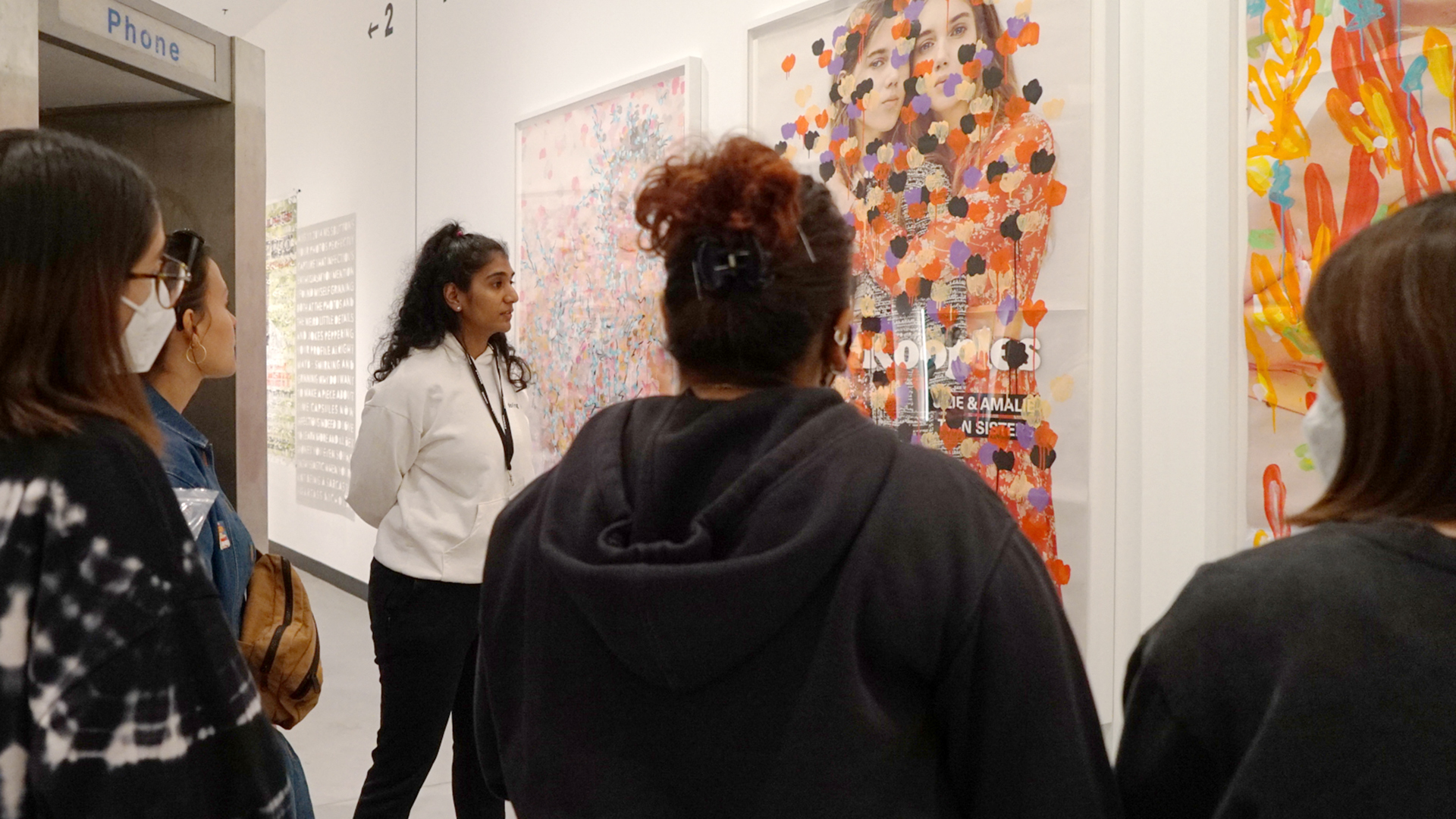Maya Varadaraj giving a tour of Poster House museum to students