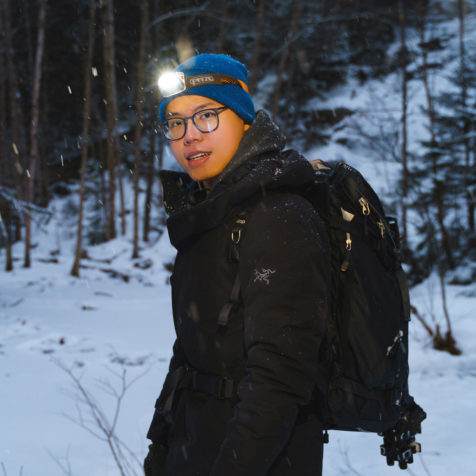 Portrait of a man in backpacking in a snowy landscape