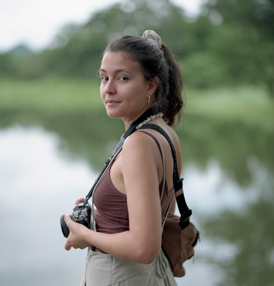 latin woman holding camera in the nature