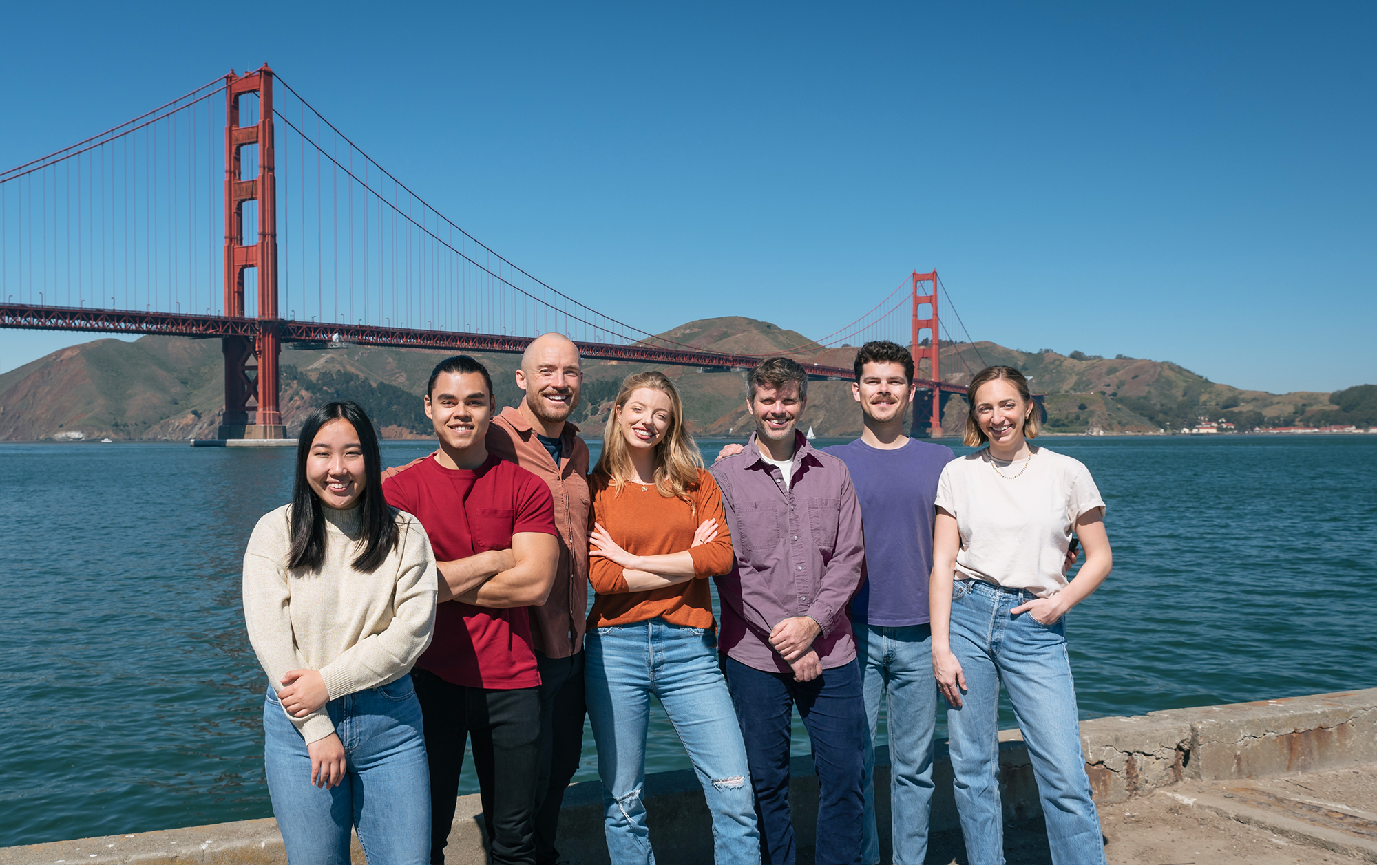 group of people in front of the golden gate bridge