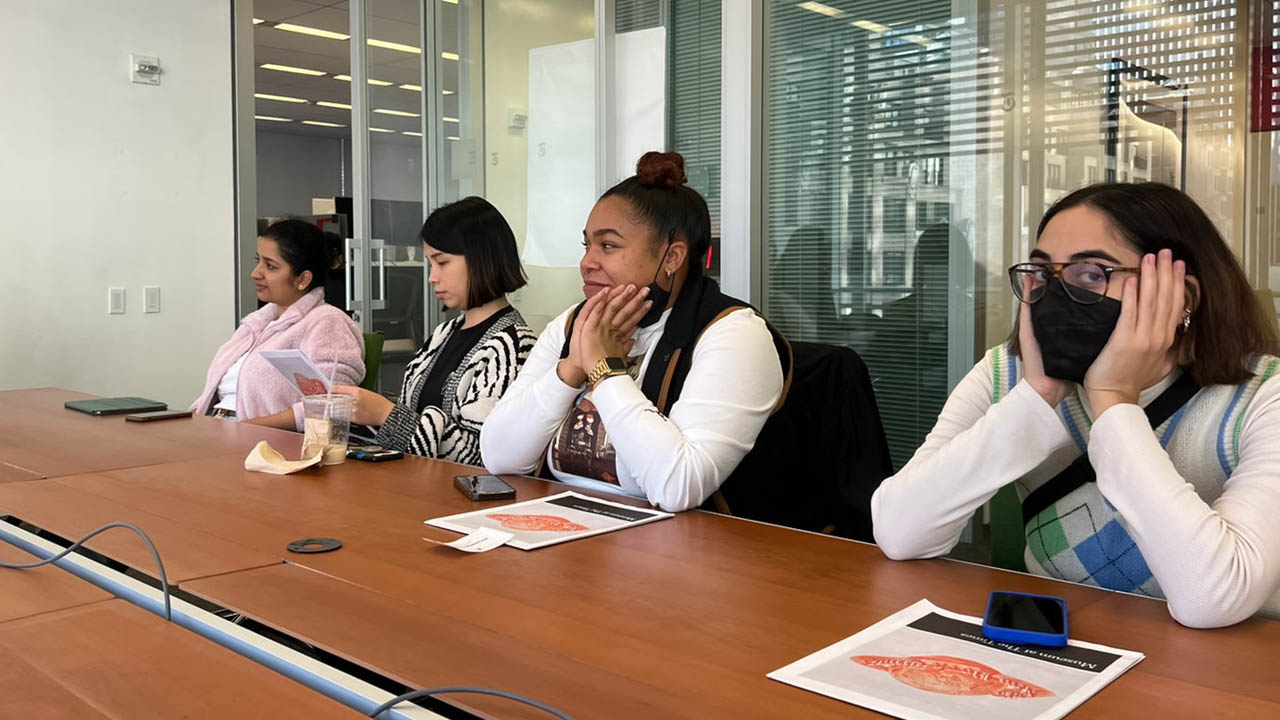 Four students sitting at a board room table in the NY Times office