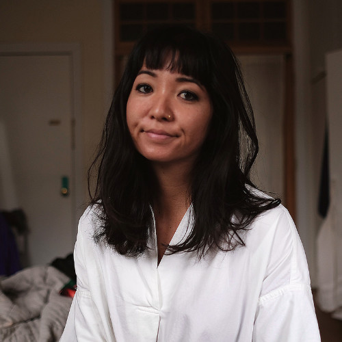 woman with black hair and white shirt
