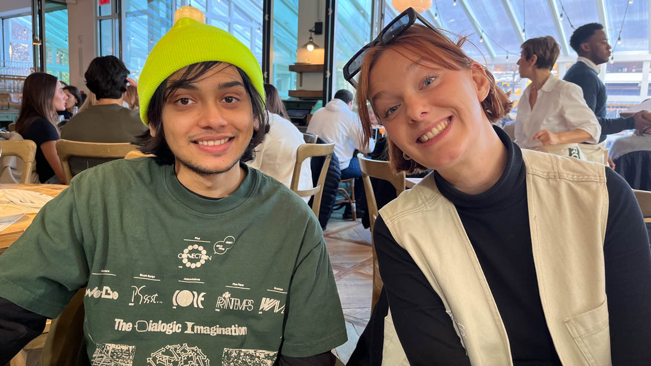 group photo of two people at a restaurant