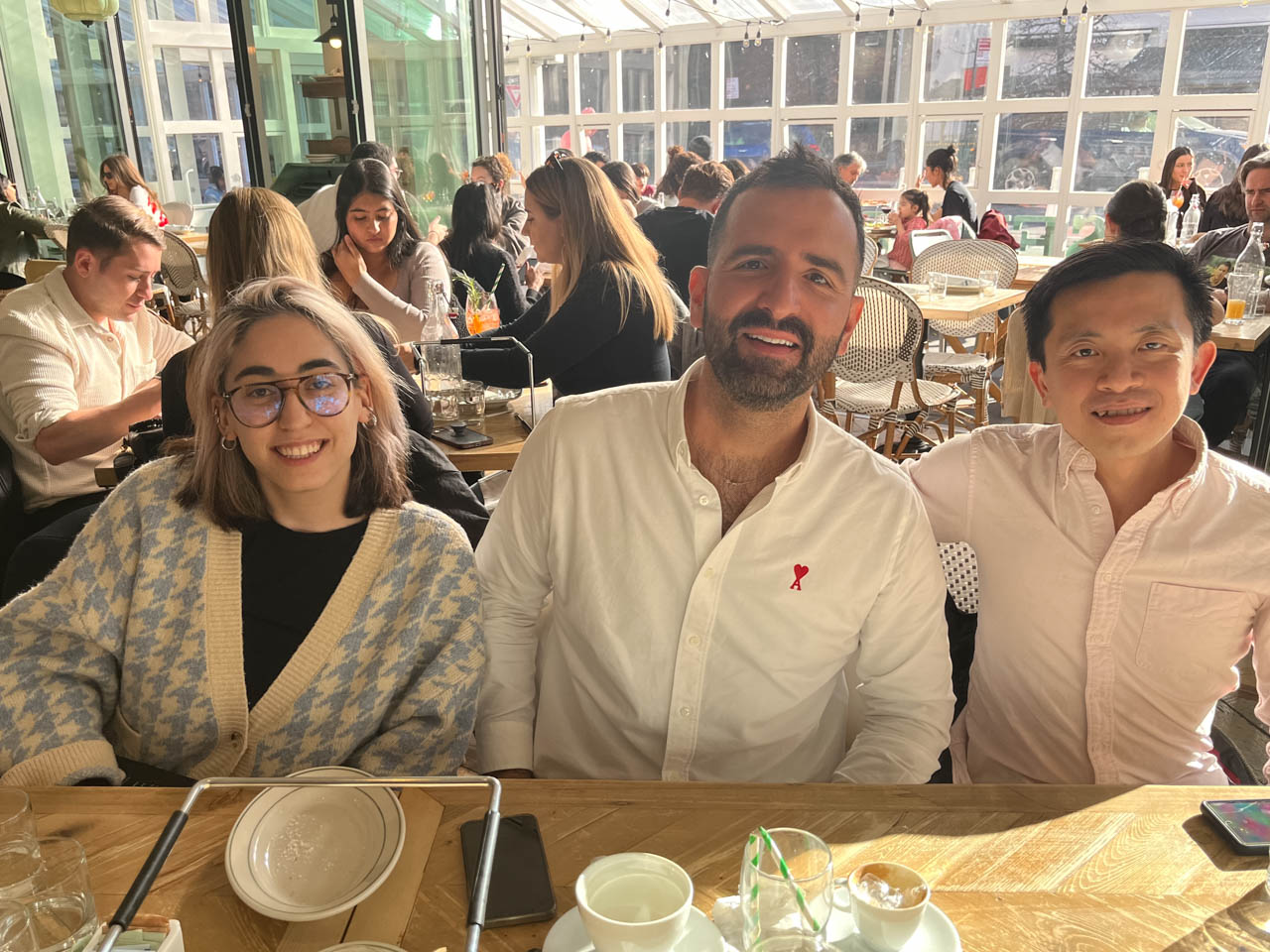group photo of three people at a restaurant