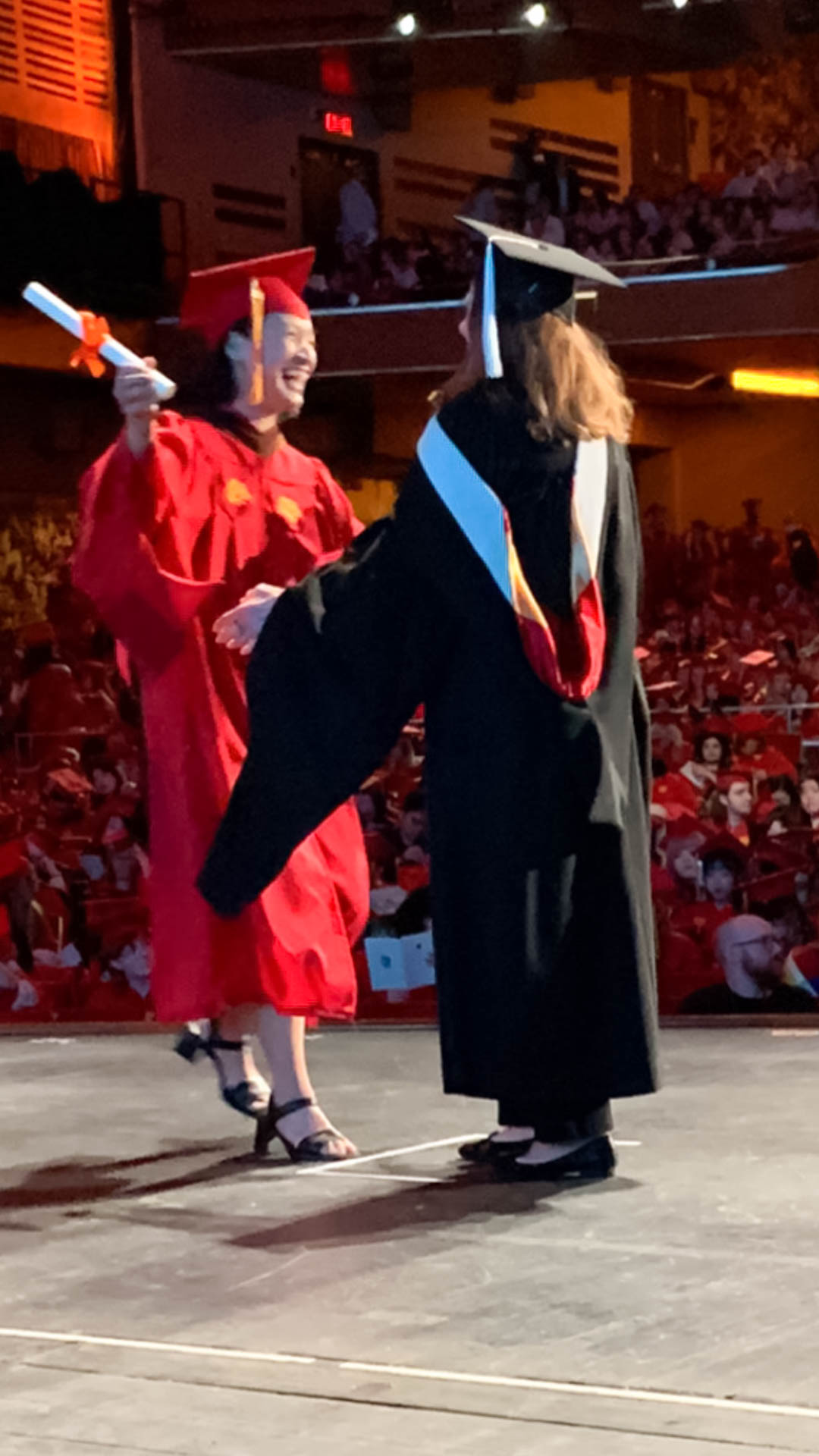 a student getting their diploma on stage