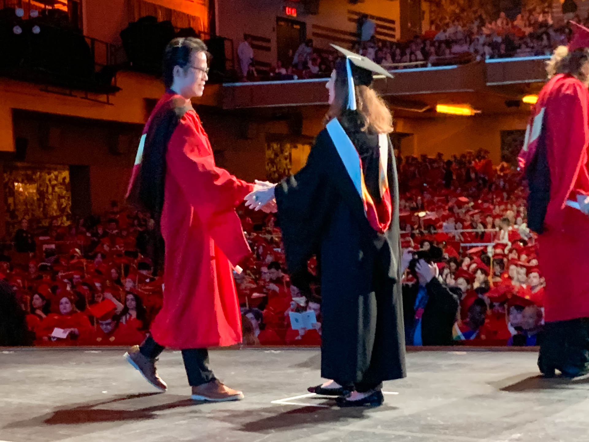 a student getting their diploma on stage