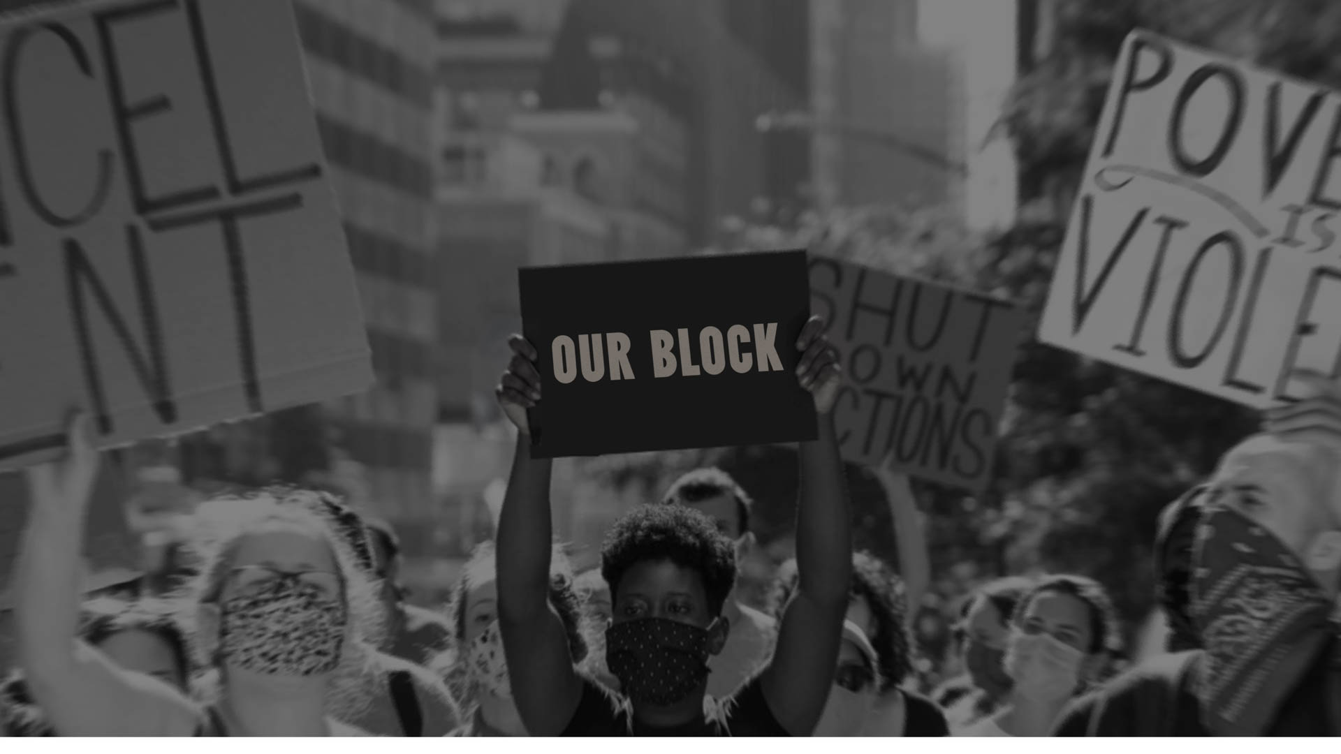 people holding up a sign during a street protest