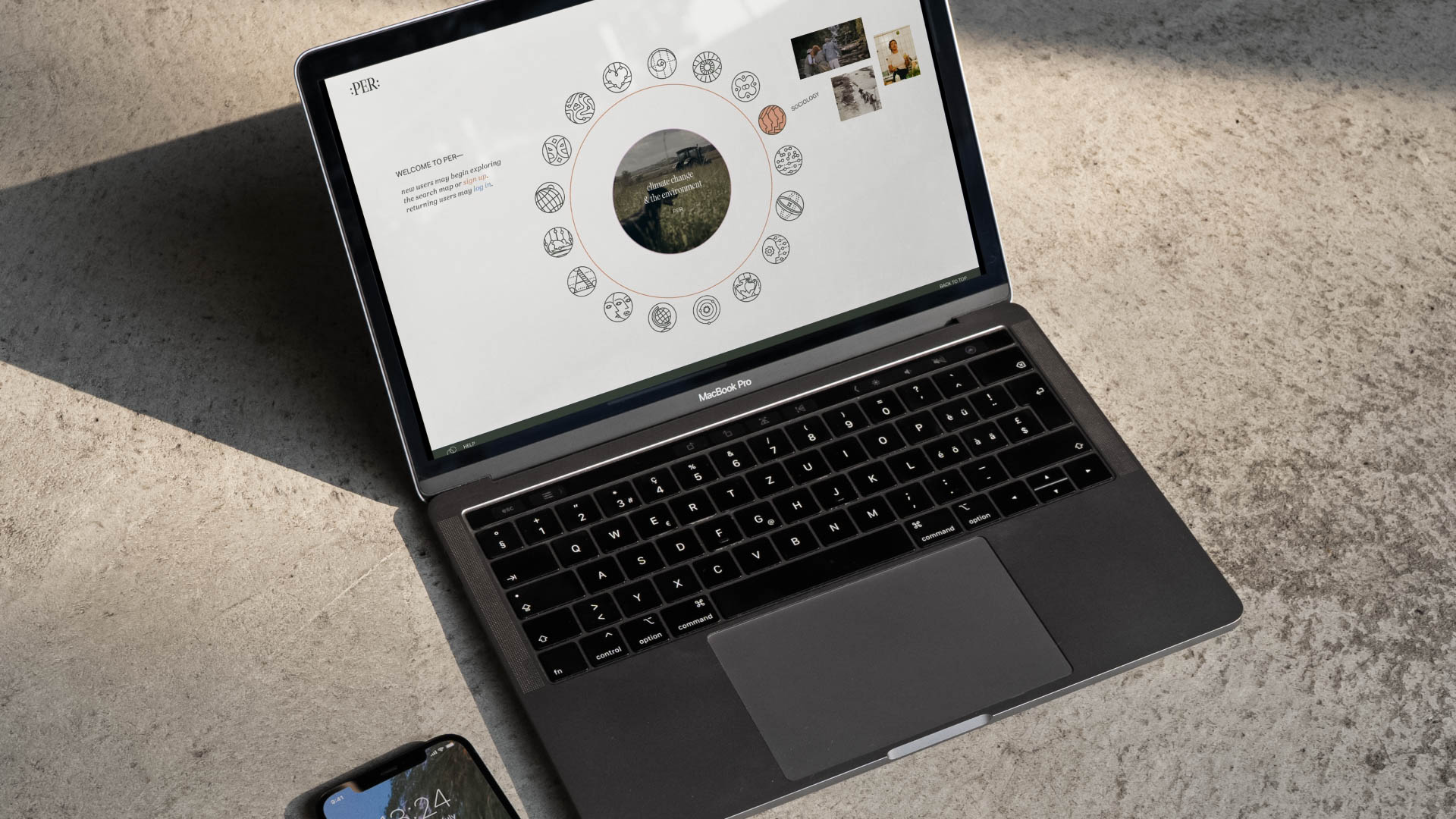 a laptop on the ground open to a webpage with circles on it