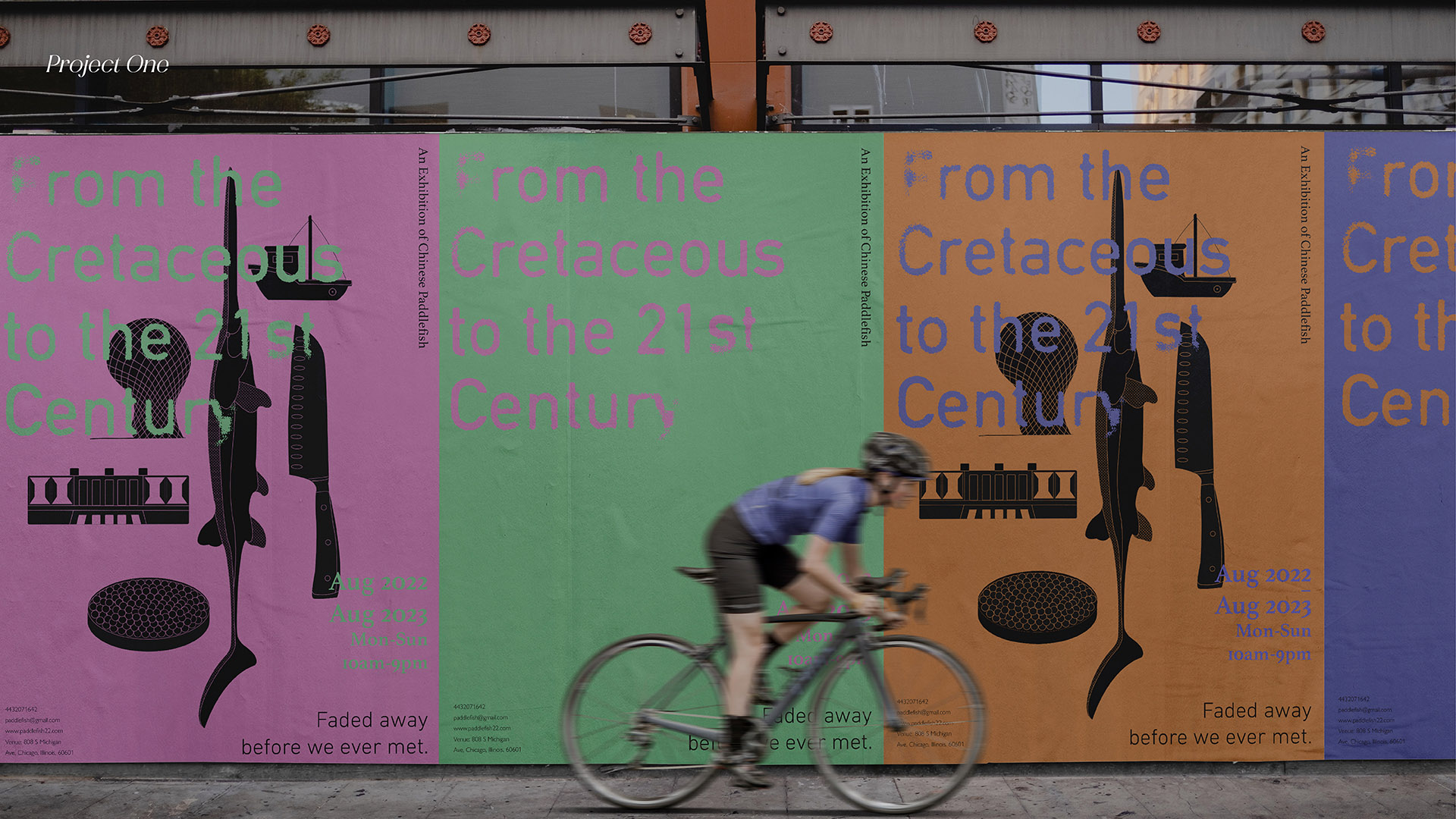 person biking past colorful posters