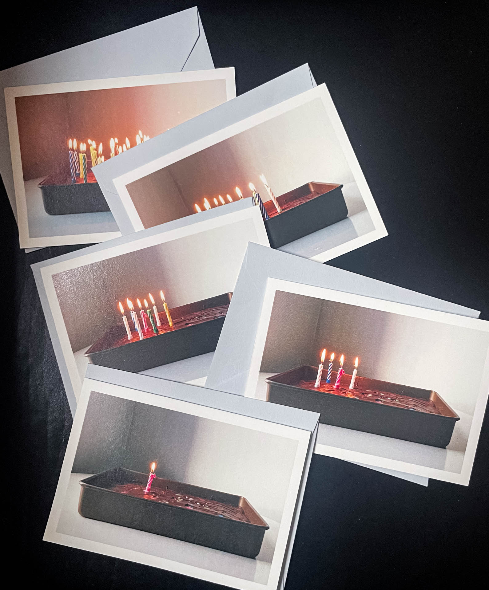polaroid photos of a cake with candles in it.