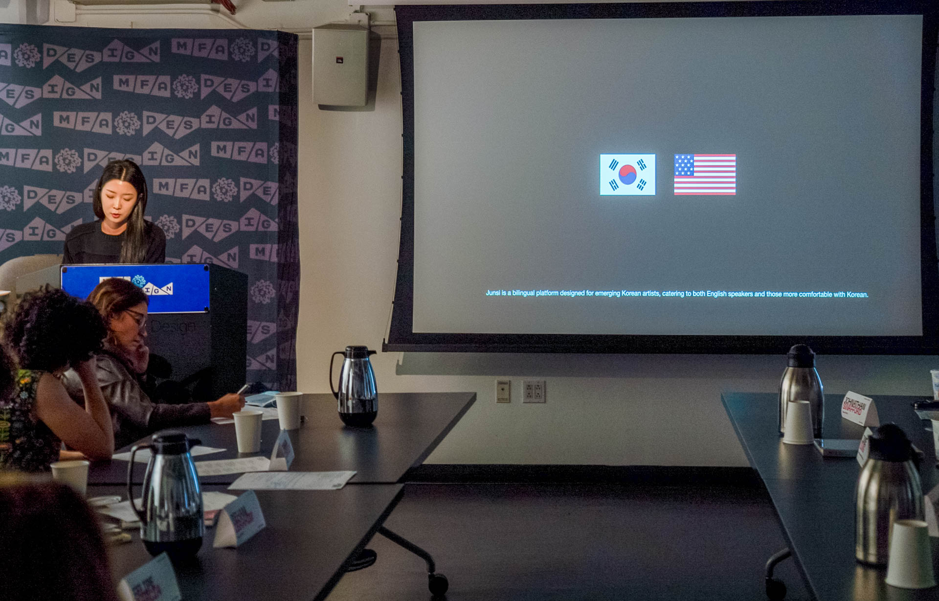 Student standing at the podium presenting Thesis work slideshow