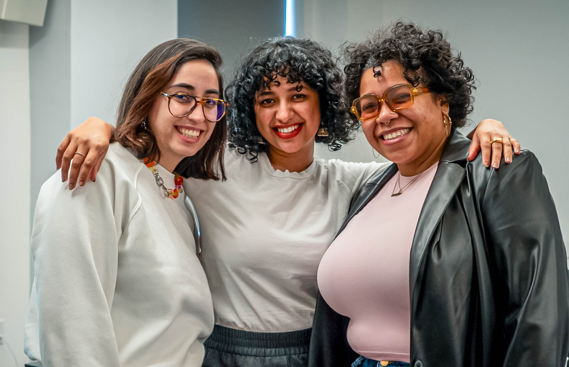 three students smiling for the camera