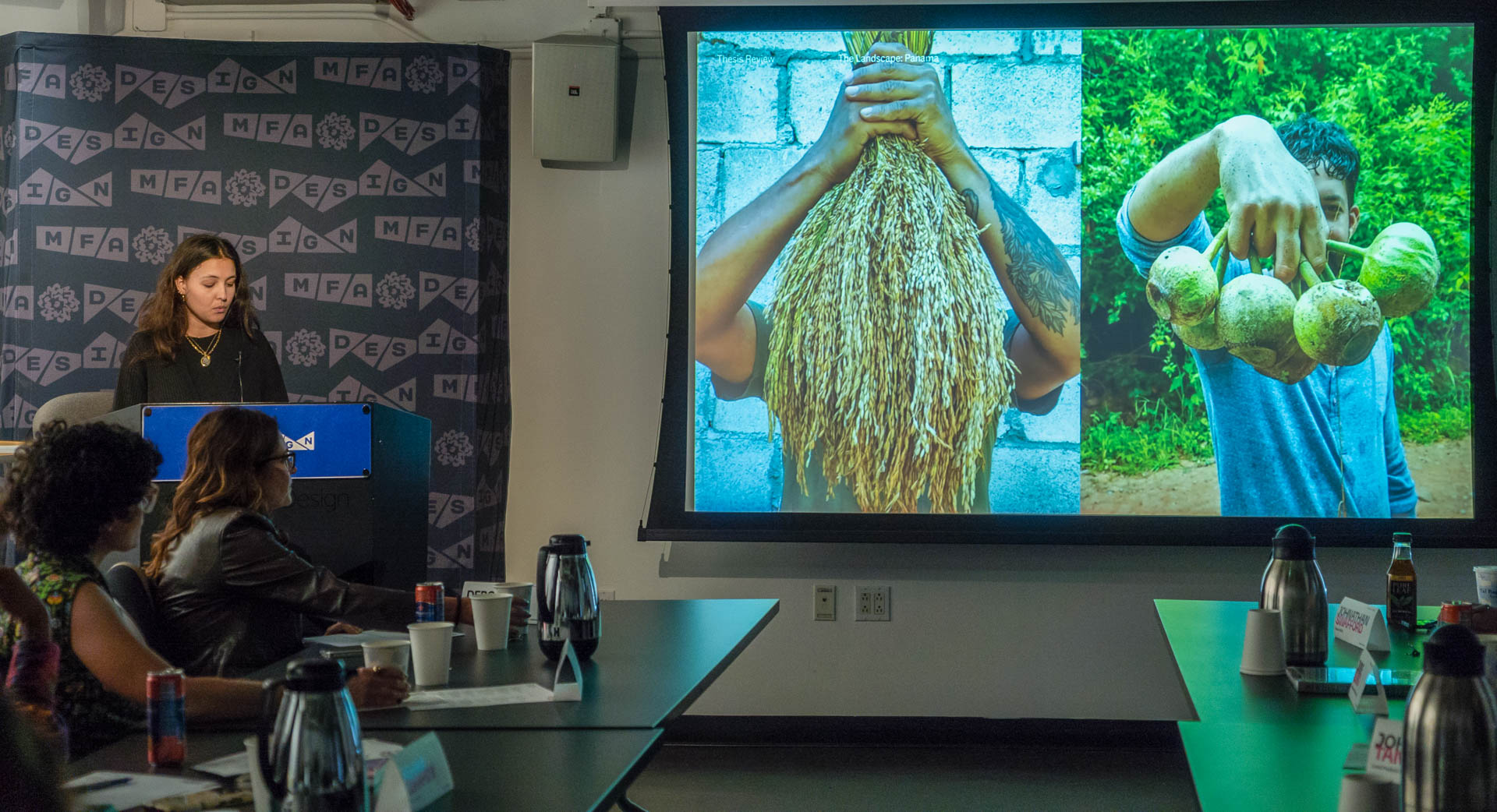 Student standing at the podium presenting Thesis work slideshow