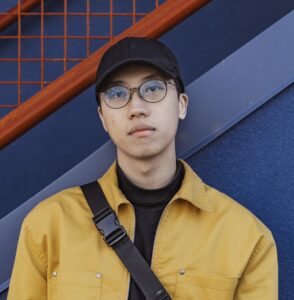 man looking at camera with yellow jacket on