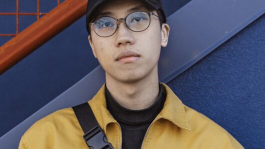 man looking at camera with yellow jacket on